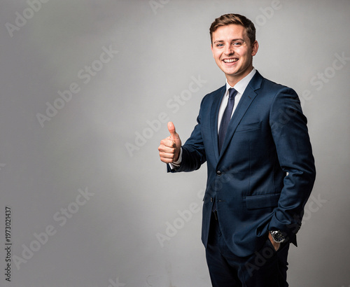 Smiling businessman giving thumbs up gesture.