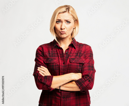 Confident woman with arms crossed standing.