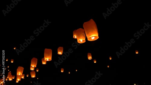 Floating Lanterns Illuminate the Night Sky During a Traditional Festival Celebration.