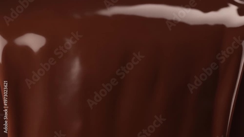 Captivating close-up of sumptuous melted dark chocolate flowing smoothly, highlighting its luxurious, ultra-thick, and creamy texture, ideal for indulgent culinary designs