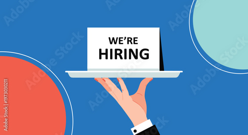 Hand of a professional server holding a silver tray with a white card displaying the text we are hiring on a bright blue background.