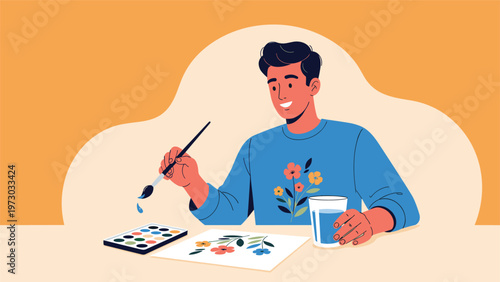 Young man with a happy expression enjoys painting colorful flowers with watercolors, demonstrating his creative hobby and artistic passion.