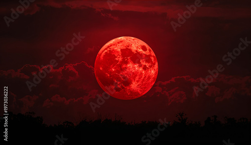 A vivid red moon dominates a dark, cloudy night sky above a silhouetted forest, creating an eerie, dramatic atmosphere.