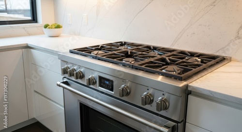 Modern stainless steel gas range stove in a kitchen setting.