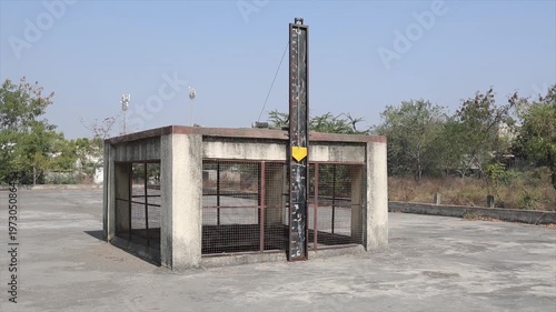 Industrial Water Measurement Gauge and Concrete Tank Structure at Outdoor Manufacturing Site.

