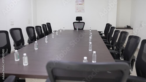 Perspective View of Empty Boardroom Table and Ergonomic Chairs in Modern Office Meeting Space.

