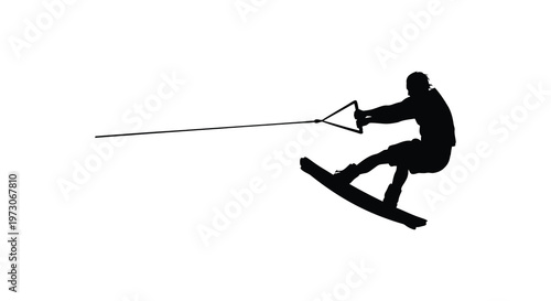 Wakeboarding athlete in action dynamic pose captured in stark black silhouette