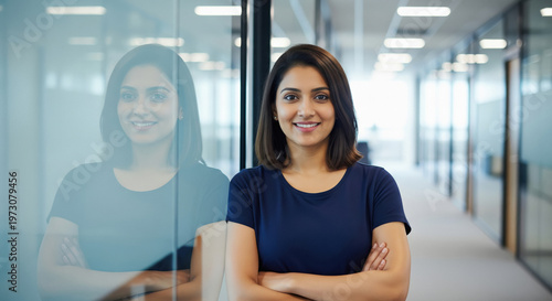 Professional woman smiling confidently in a modern office environment Free Download Professional woman smiling confidently in a modern office environment - GFXLoad