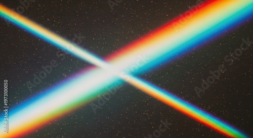Two intersecting beams of light displaying a full spectrum of colors against a dark, speckled background, creating a vibrant X-shape.
