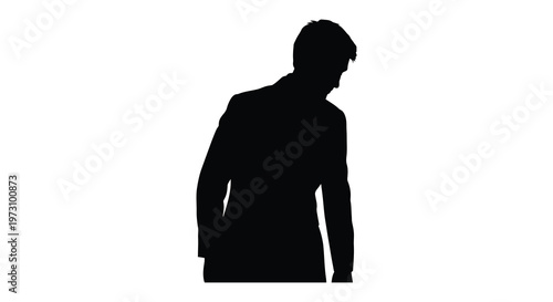 A contemplative man with head bowed captured in a stark silhouette