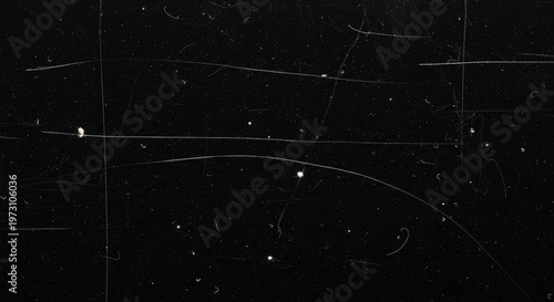 Abstract dark background with white scratches, dust, and distressed film grain texture.