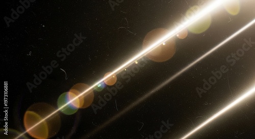 Bright, glowing light beams with colorful lens flares and dust particles against a dark background, creating a cinematic effect.