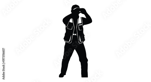 Photographer capturing a moment seen in striking black form silhouette