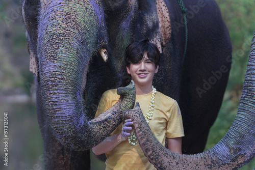 Bilde på lerret Young man smiling with elephant trunk during songkran festival celebration in ou