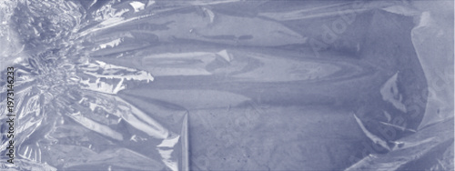 Wrinkled plastic film texture with dotted halftone effect. Abstract crumpled cellophane background with soft folds and transparent material look. Concept of packaging, recycling, material surface.