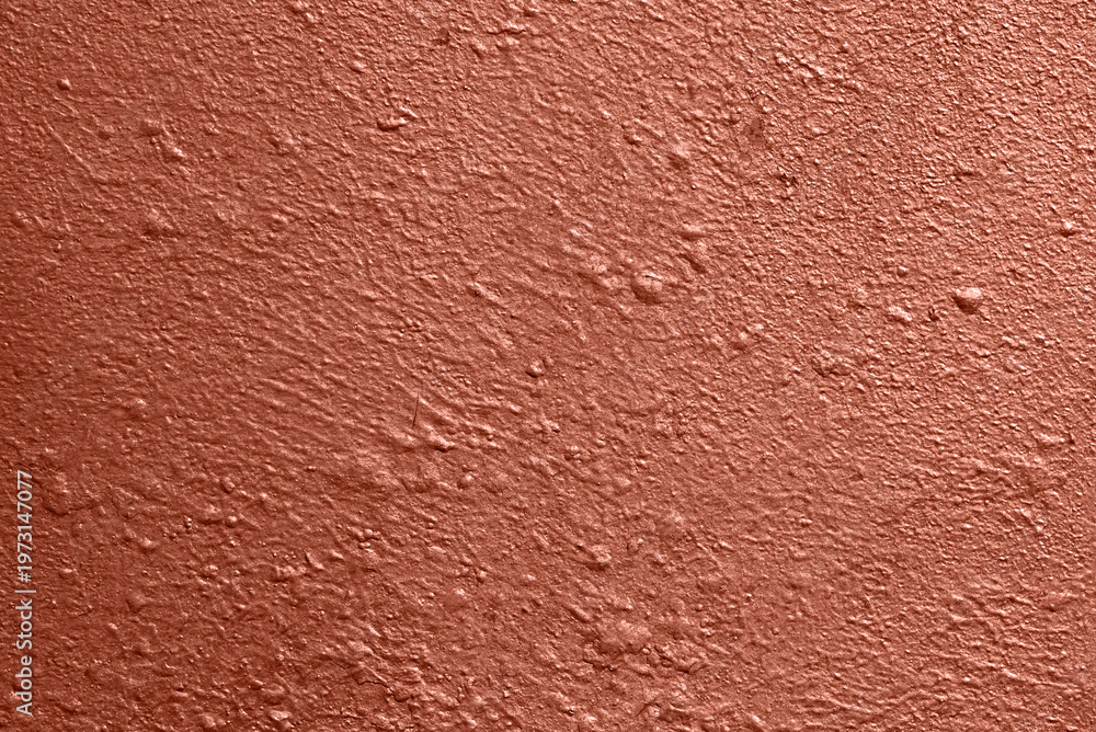 Fototapeta premium Painted metallic wall with warm red pearlescent coating, uneven surface and fine texture, abstract background for design.