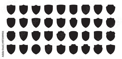 Large collection of solid black shield silhouettes for heraldic crest design and security company branding use.