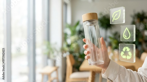 Refillable glass bottle with sustainability icon cards in bright eco office with copy space for product responsibility report cover website header and reusable packaging content