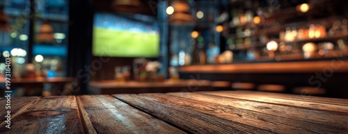 Empty wooden table in pub with sports TV on background  