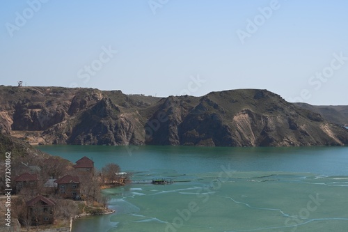 Early spring water surface with ice.  Kapshagay Reservoir. Konaev city.