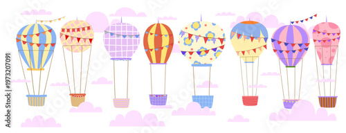 Set of eight classic hand drawn hot air balloons with flags floating above pink clouds for spring decoration baby shower or children bedroom