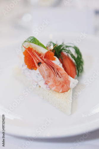 Fotografie Classic Swedish Toast Skagen appetizer featuring creamy prawn salad on toasted bread, topped with fresh shrimp, red bleak roe, a lime wedge, and dill