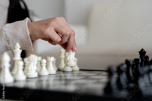 Tableau sur toile Close up of hand moving piece on chessboard for business strategy and decision m