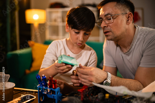 Father and son bonding while repairing hobby toy car