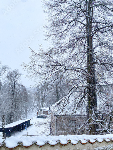 White snowy, fairy tale village, houses, castle and tower covered by snow in winter in Cesky Krumlov, UNESCO world heritage site in the South Bohemian region, Czech republic, Czechia 
