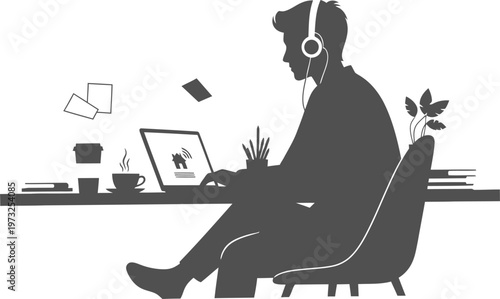 Man wearing headphones working remotely from home on laptop computer