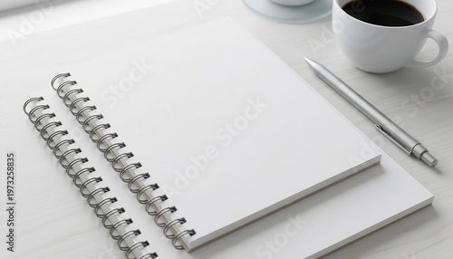 Notebooks and a cup of coffee are placed on a desk during daylight hours for work and study activities