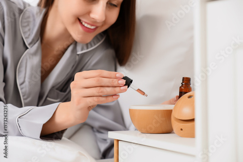 Young woman dropping essent...