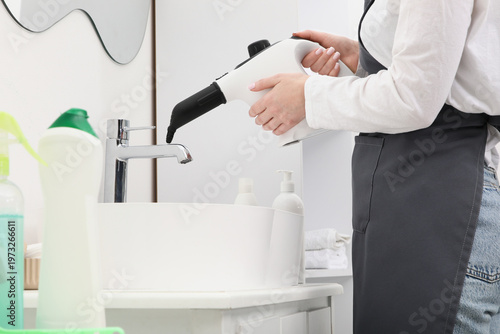 Female janitor steam cleani...