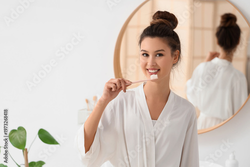 Beautiful young woman brush...