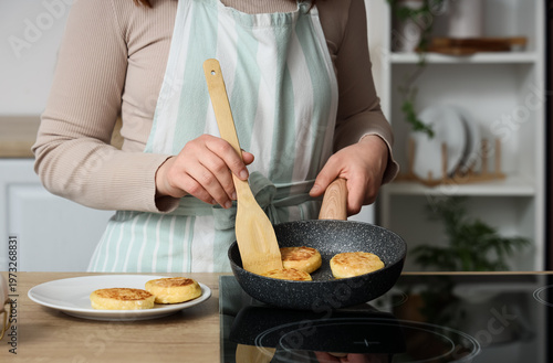 Woman frying cottage cheese...