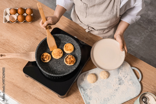 Woman frying cottage cheese...
