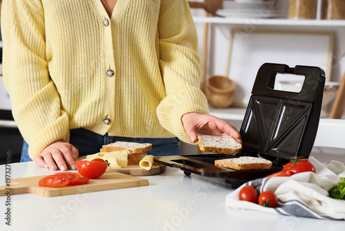 Young woman using sandwich ...