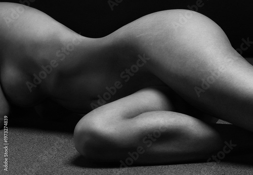 Naked woman Yoga on black background. Fine art photo of female body.	
