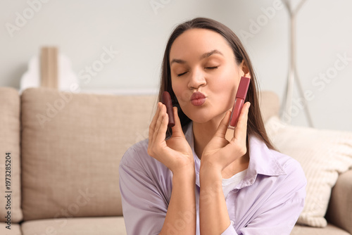 Young woman with lipsticks ...