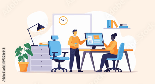 Two people collaborating on a computer in an office setting.