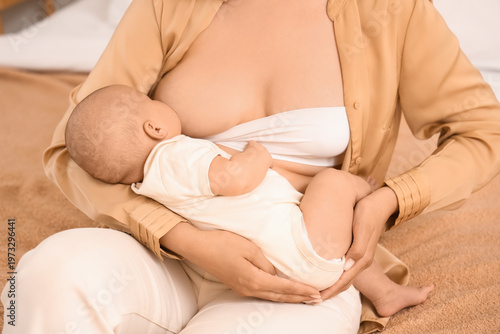 Young woman breastfeeding h...