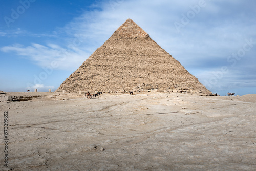 Horse drawn carriage awaits tourists in front of Great Pyramid on sunny day, Cairo, Egypt