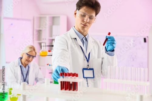 Male chemist with test tubes in laboratory