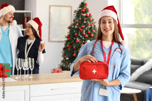 Female doctor in Santa hat ...