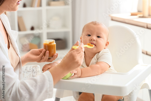 Mother feeding her baby in ...