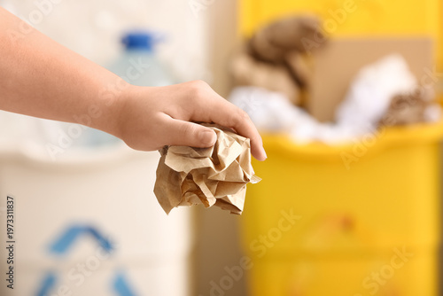 Woman throwing garbage into...
