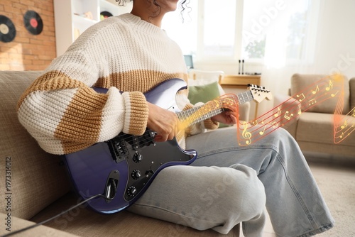 Young woman playing electri...