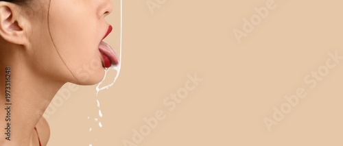 Foto White liquid pouring into woman's mouth on beige background with space for text, closeup