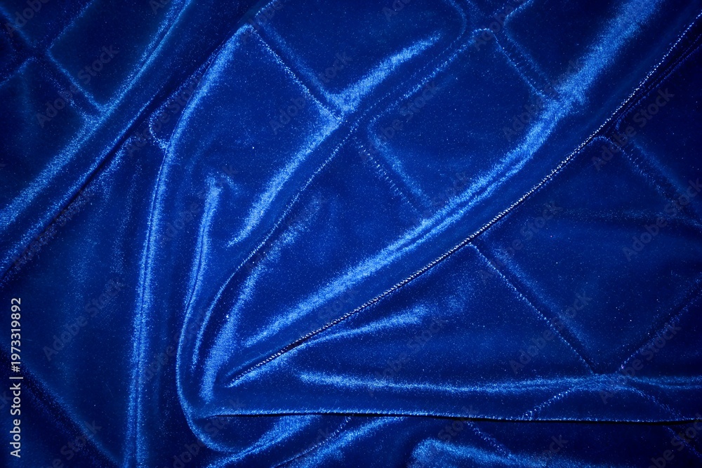 Fototapeta premium luxurious navy blue quilted velvet fabric texture with linear parallel stitching