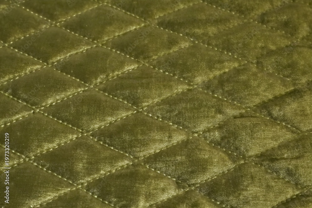 Fototapeta premium luxurious olive green quilted velvet fabric texture with diamond stitch pattern 